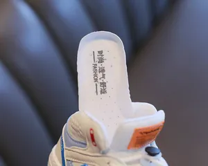 Close-up of breathable white insole in children's high-top color-block sneakers