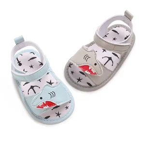 Detail view of cute cartoon shark baby sandals in light blue and grey colors