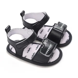 Close-up of black baby sandals with cartoon crocodile and soft sole for 1-year-olds