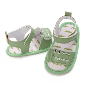 Detailed shot of green baby sandals with cute cartoon crocodile embroidery