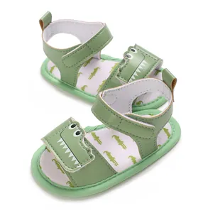 Close-up detail of green baby summer sandals featuring a cute 3D cartoon crocodile design.