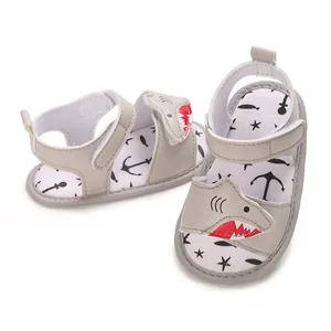 Macro view of cartoon shark motif on grey baby soft sole toddler sandals