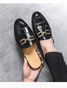 Detailed view of black crocodile pattern men's casual slip-on loafers with gold buckle