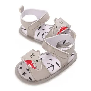 Detailed view of grey shark-themed baby sandals with soft sole and cartoon patterns