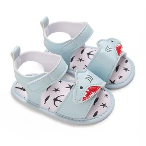 Detailed view of light blue baby shark sandals with cartoon design and soft soles