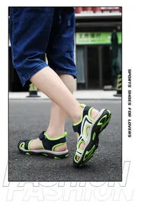 Close-up of green and blue closed-toe children's sandals in outdoor lifestyle setting.