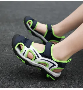 Side view of boys' breathable closed-toe outdoor sandals on feet showing straps