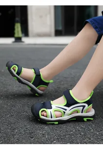 Close-up view of navy and lime green boys' breathable sport sandals with mesh panels