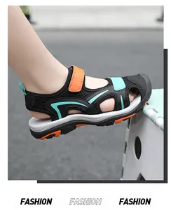 Detailed side view of black and orange breathable closed-toe sandals for boys
