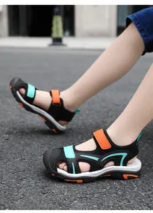 Detailed view of children's breathable closed-toe sandals in black and orange