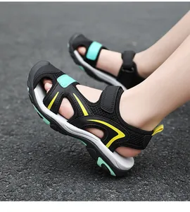 Side view detail of breathable black boys closed-toe sandals with yellow accents