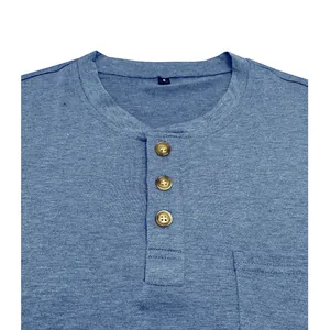 Close-up of blue Henley T-shirt with three wood-toned buttons and chest pocket detail
