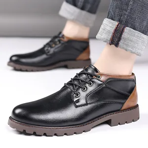 Close-up detail of men's low-top black and brown leather work boots with lace-up style