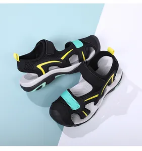 Close-up of breathable closed-toe kids sandals in black mesh with yellow accents