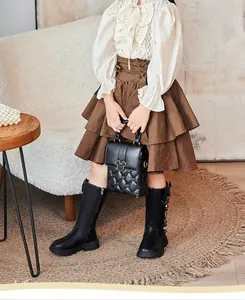 Stylish black high-top boots for girls featuring delicate bow and pearl details