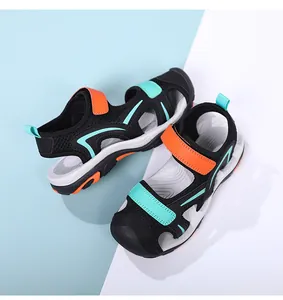 Close-up top view of breathable children's sports sandals in black, orange, and teal colors