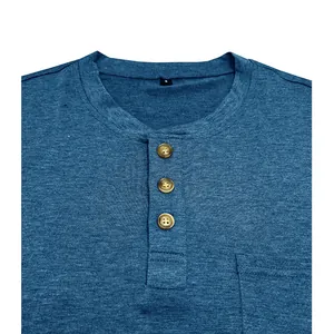 Close-up detail of men's blue Henley shirt collar with three buttons and pocket
