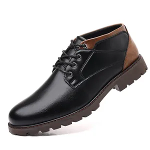Detail of men's low-top work boots in black and brown leather with lug sole