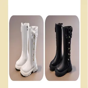 Elegant girls' high-top Martin boots in black and white featuring stylish side bow accents.