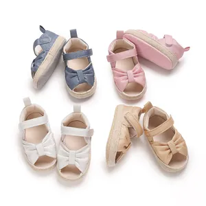 Detail shot of various colorful baby sandals with cute bow design and soft soles
