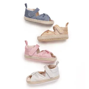 Detail of four colorful soft-soled baby sandals in blue, beige, pink and silver
