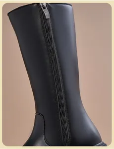 Close-up of the back zipper and premium black leather texture on girls' high boots