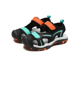 Sporty black and orange kids' closed-toe sandals presented on a clean white background