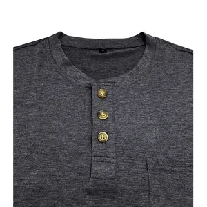 Macro detail of a dark grey men's Henley shirt featuring a button placket and pocket.