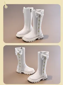 Elegant white high-top princess boots for girls featuring a large bow and delicate lace trim