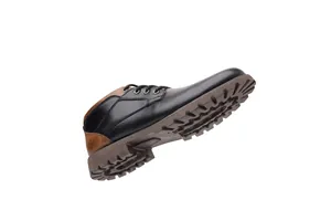 Close-up of low-top men's Martin boots with lugged rubber sole and black leather upper