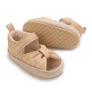 Detailed view of shiny baby sandals with textured fabric and non-slip dotted soft sole.