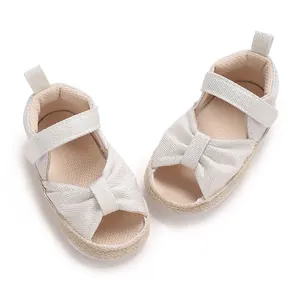 Detailed macro view of comfortable soft-soled baby sandals with a cute bow accent