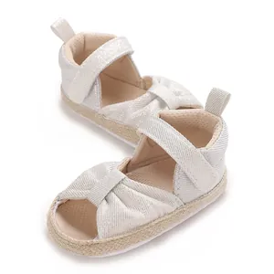 Close-up of sparkling silver baby sandals with soft sole and hook-and-loop strap
