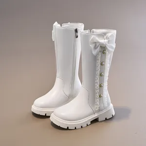 Elegant white girls' high-top boots featuring bow and pearl details for autumn performance