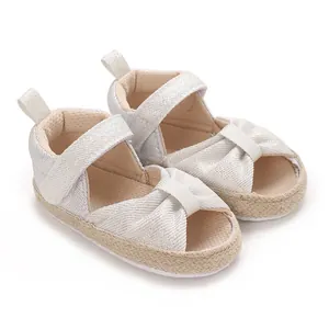 Close-up of baby soft-sole sandals in shimmering silver with espadrille detail