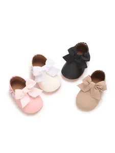 Group of baby girl princess shoes with large bows in pink, white, black, and beige