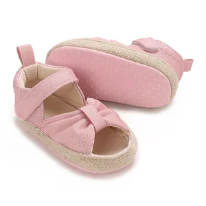 Detail view of pink baby sandals with soft non-slip sole and glittery fabric finish