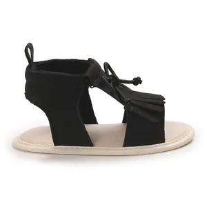 Side view of black infant tassel sandals with soft anti-slip soles for baby girls