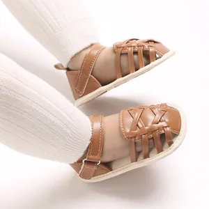 Détail des sandales pour bébé en cuir tressé marron avec semelles souples pour l'été
