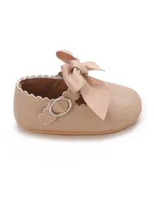 Elegant beige PU leather baby princess shoe with large ribbon bow and scallop detail