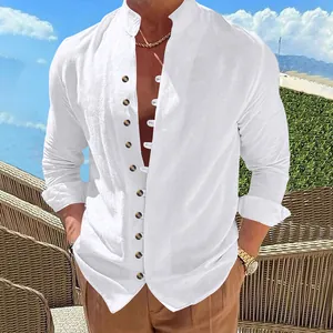 Detailed view of white linen long-sleeved shirt with band collar and brown buttons.
