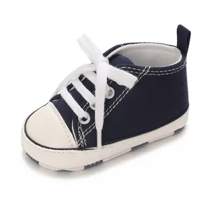 Close-up of navy blue and white canvas baby sneaker with soft sole and white laces