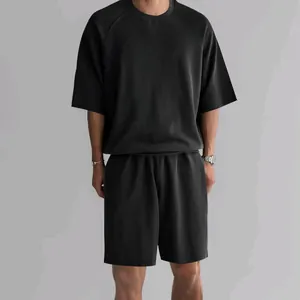 Close-up detail of men's black terry cotton two-piece lounge set featuring a relaxed fit