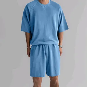 High-quality detail shot of men's light blue terry cotton short sleeve and shorts set