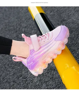 Detailed view of pink and purple girl's sports shoes with hook-and-loop strap design