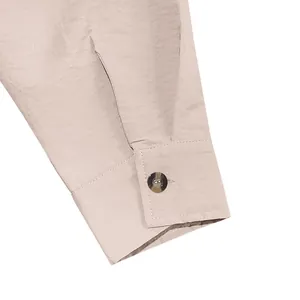 Macro view of a buttoned cuff on a vintage linen long-sleeved shirt for men