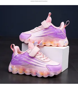Detailed view of pink and purple children's sneakers with colorful chunky soles