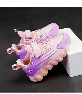 Side view of pink and purple girls sneakers with velcro strap and decorative wavy sole