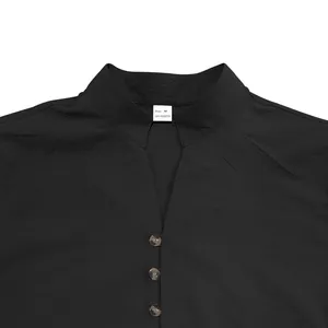 Detailed close-up of a black men's vintage shirt with V-neck collar and buttons.