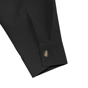 Close-up of black retro linen shirt cuff with stitching and button detail